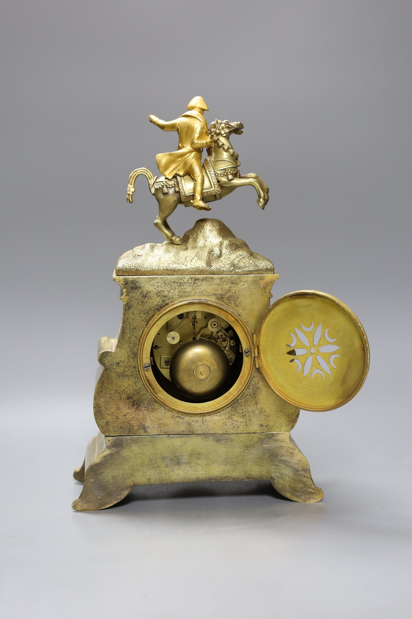 A French ormolu silk suspension clock depicting Napoleon on horseback, with pendulum, 36cm tall